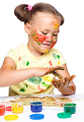 Image showing Portrait of a cute girl playing with paints