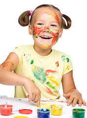 Image showing Portrait of a cute girl playing with paints