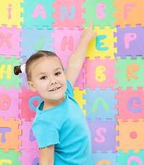 Image showing Little girl is pointing at letter B