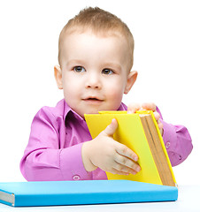 Image showing Little child play with book