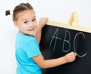 Image showing Little girl is showing letter E on the alphabet