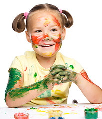 Image showing Portrait of a cute girl playing with paints