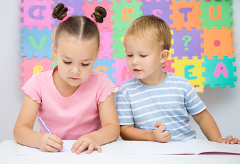 Image showing Children are writing on their books