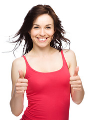 Image showing Woman is showing thumb up gesture