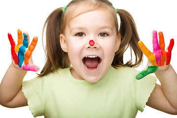 Image showing Portrait of a cute girl playing with paints