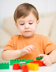 Image showing Boy is playing with building blocks