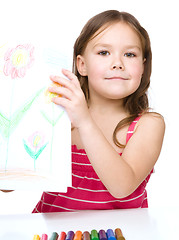 Image showing Little girl is showing her drawing