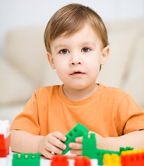 Image showing Boy is playing with building blocks