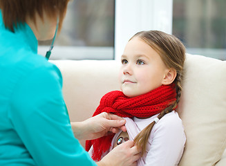 Image showing Doctor is examining little girl using stethoscope