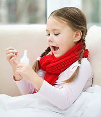 Image showing Little girl spraying her nose