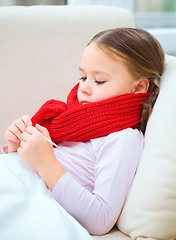 Image showing Ill little girl is reading thermometer