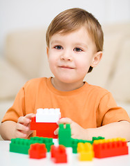 Image showing Boy is playing with building blocks