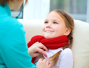 Image showing Doctor is examining little girl using stethoscope