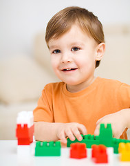 Image showing Boy is playing with building blocks