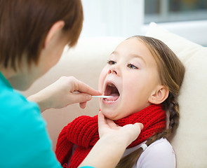 Image showing Doctor is examining little girl