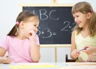 Image showing Little girls are writing using a pen