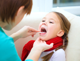 Image showing Doctor is examining little girl