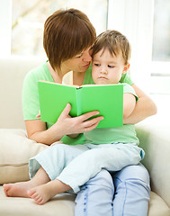 Image showing Mother is reading book for her son