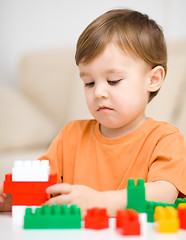 Image showing Boy is playing with building blocks