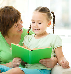 Image showing Mother is reading book for her daughter