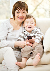 Image showing Mother and her son are watching tv show