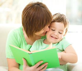 Image showing Mother is reading book for her son