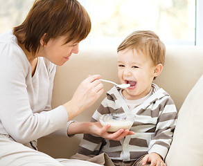 Image showing Mother is feeding her son