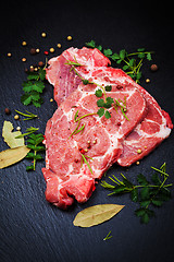 Image showing Fresh raw pork meat on black board