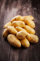 Image showing Fresh organic potatoes on a wooden table