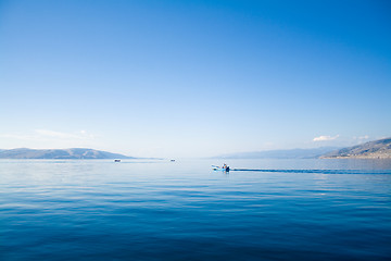 Image showing blue sky above a blue surface of the sea