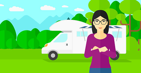 Image showing Woman standing in front of motor home.