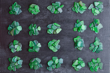 Image showing small green pieces of glass polished by the sea