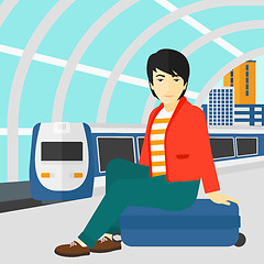 Image showing Man sitting on railway platform.