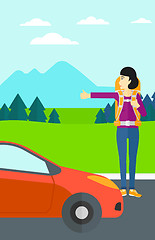 Image showing Young woman hitchhiking.