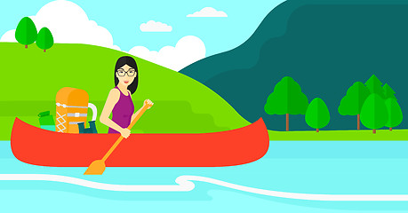 Image showing Woman canoeing on the river.