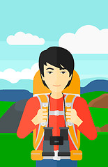Image showing Cheerful backpacker with binoculars.