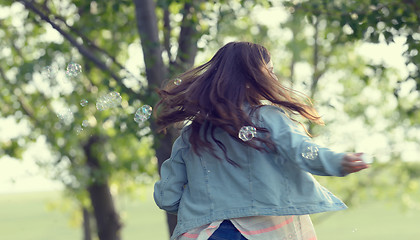 Image showing Young girl play with soap-bubbles