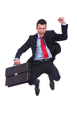 Image showing very happy young business man jumping
