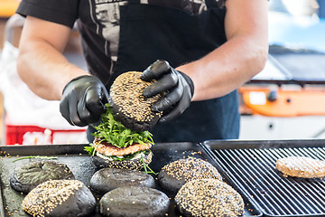 Image showing Beef burgers ready to serve on food stall.