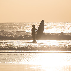 Image showing Surfers on beach with surfboard.