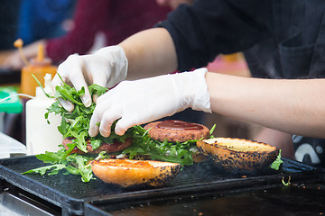 Image showing Beef burgers ready to serve on food stall.