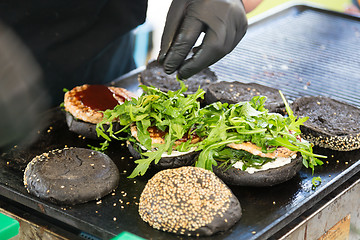 Image showing Beef burgers ready to serve on food stall.