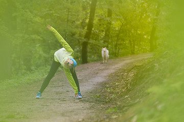 Image showing Sporty woman  working out in forest. 