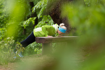 Image showing Sporty woman  working out in forest. 