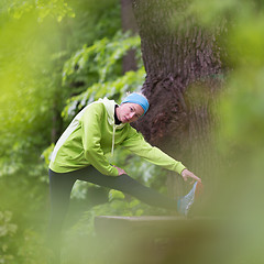Image showing Sporty woman  working out in forest. 