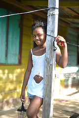 Image showing native Nicaraguan girl smiling  clapboard house Big Corn Island 