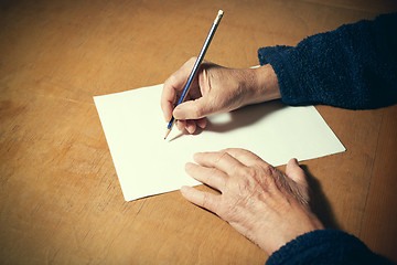 Image showing Senior man with blank white paper sheet and pencil