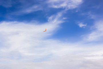 Image showing Orange boomerang flying in the sky