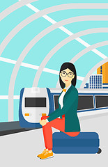 Image showing Woman sitting on railway platform.