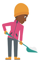 Image showing Woman shoveling and removing snow.